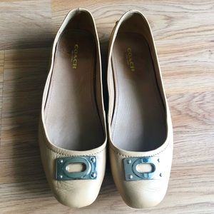 Coach neutral tone flats with gold detail.